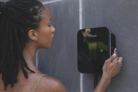 Woman using Fast Hardwired Level 2 EV Charger With NACS Tesla Connector Forty Eight Amps Eleven Point Five Kilowatts Wall Mount EVSE