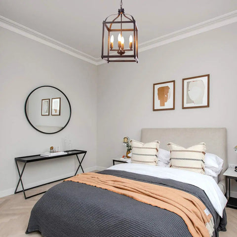 Industrial Pendant Light With Classic Black Metal Cage For Farmhouse And Modern Homes in a bedroom setting above a bed