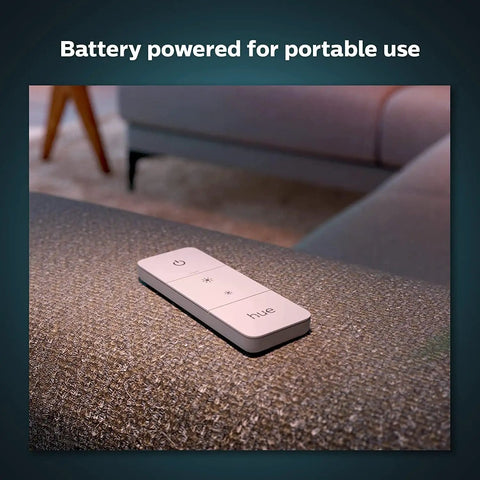 Smart Wireless Dimmer Switch V2 for Hue Lights No Bridge Needed on a couch, battery-powered remote for indoor lighting control