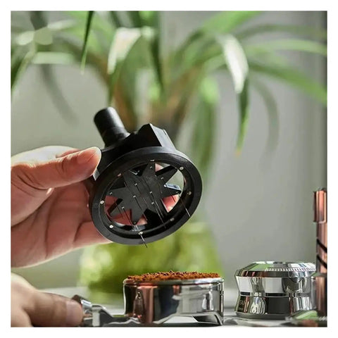 Slick Pro Grade Heavy Duty Adjustable Rotary Espresso Tamper And Coffee Distribution Spoon Levels Grounds Smooth For 51Mm 54Mm 58Mm Portafilters in hand above coffee grounds.