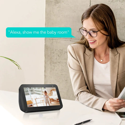 Woman using device displaying "Alexa, show me the baby room" next to 1080P HD Indoor Home Security Camera with 2.4GHz WiFi Smart AI Detection.