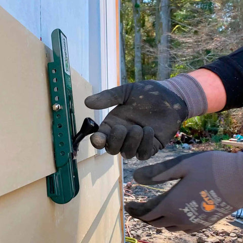 Person using Gecko Gauge Siding Installation Kit For 5/16 Inch Fiber Cement And James Hardie Siding with Pro Grip Clamp outdoors.