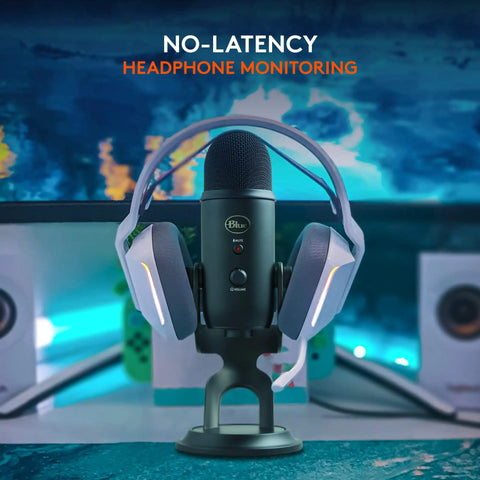 Blue Yeti USB Microphone For PC And Mac with headphones, ideal for streaming, gaming, and podcasts on a desk setup.