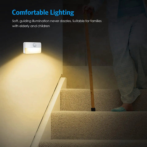 4 Pack Mini Motion Sensor Stair Lights Battery Powered Cordless LED Night Lights on a staircase, illuminating steps with a warm glow
