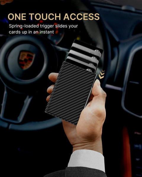 Hand holding Pop Up Aluminum Card Wallet With RFID Blocking in carbon fiber look, showing card ejection by car dashboard.
