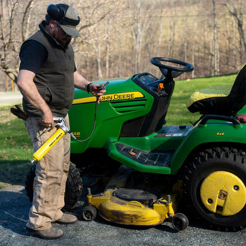 LockNLube Premium Pistol-Grip Grease Gun, side view, with 20-inch hose and inline swivel, yellow body.