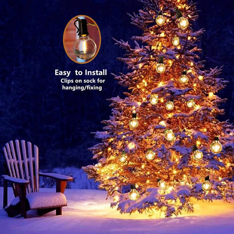 Snowy tree and chair lit by two pack 100 foot outdoor string lights with dimmable G40 LED bulbs that are shatterproof and weatherproof