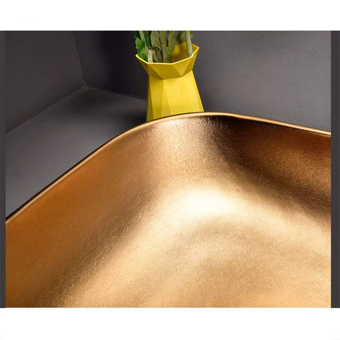Close-up of Killer Top Shelf Porcelain Vessel Sink for Above Counter Bathroom Vanity in gold finish.