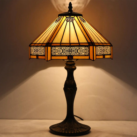 Yellow Hexagon Tiffany Style Stained Glass Lamp For A Cozy Vibe Mission Table Desk Bedside Reading Light 12 Inch Shade 18 Inch Tall With Antique Green Bronze Base UL Listed Cord Switch Perfect For Bedroom Or Living Room Decor glowing softly in dimly lit room
