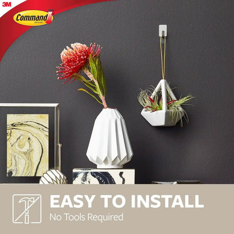 Small Stainless Steel Hooks Set With Eight Hooks And Ten Strips Holds Up To 0.5 lb Removable Self Adhesive Wall Hangers No Tools Needed For Damage Free Organization And Easy Wall Decor showing hanging decor and easy installation