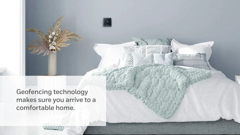 Smart Thermostat T5 Black ENERGY STAR Certified on bedroom wall with comforter, promoting geo-fencing and easy temperature control.