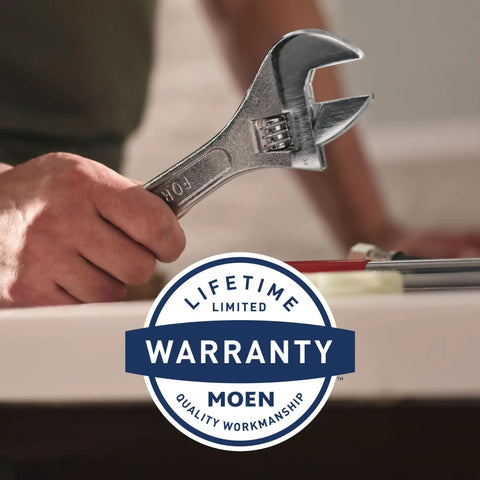 Person holding a wrench near a sink with Moen lifetime warranty badge, for PosiTemp Rough In Pressure Balancing Shower Valve For Half Inch CC