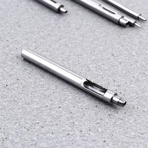 Leather Hole Puncher Set Five Piece With Steel Hollow Round Punch Tools 1-5mm on gray background, close-up view.