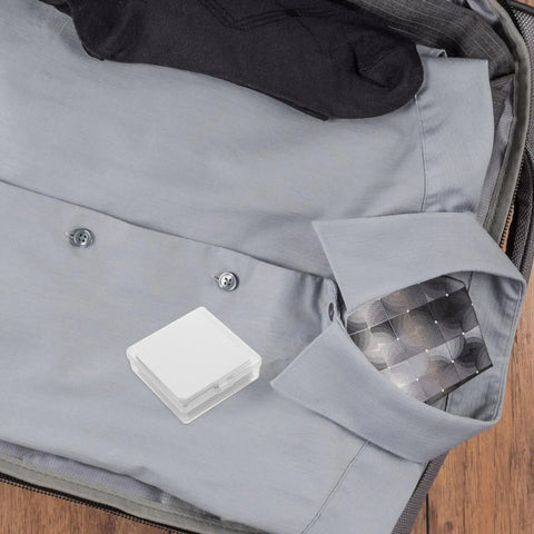 Durable Eighty Piece PVC Shirt Collar Stays Lock Down Sharp Looks On Dress Shirts Keeping Them Crisp Without Sagging Or Wrinkling During Daily Grind Hours in suitcase with gray shirt and socks.