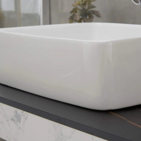 Close-up of Rectangle Vessel Sink With Pop Up Drain Included For Above Counter Bathroom White Porcelain Ceramic Vanity Basin 14.6 X 18.9 X 5.2 Inches Without Faucet Hole displayed on a dark countertop.
