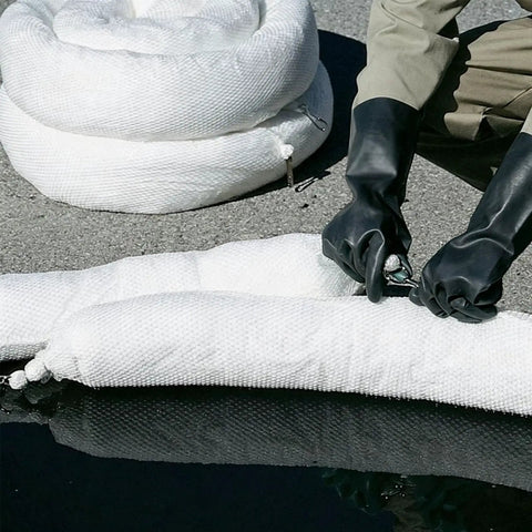 Heavy Duty Oil Spill Containment Booms 3 Pack Polypropylene Sorbent Socks being handled by gloved hands near water.