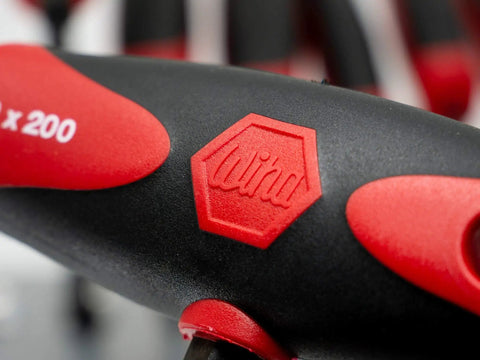 Close-up of red and black handle from Metric T Handle Set With Soft Grip Ball End Hex Tools Eight Piece For Maximum Torque.