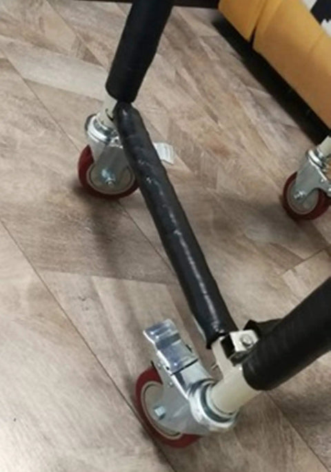 Beefed Up Polyurethane Caster Wheels With Dual Brakes set of four attached to furniture leg