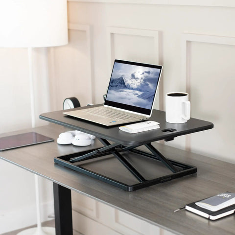 Ultra Slim Single Top Standing Desk Riser Height Adjustable Sit Stand Converter with laptop and coffee on desk