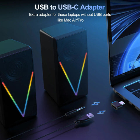 Desktop Computer Speakers With 6 Colorful RGB Lights USB Powered HiFi Stereo 2 Channel Enhanced Bass And Volume Control 3 5mm Aux Headphone Jack For Laptop Monitor PC Tablet And Phone next to a laptop with USB to USB-C adapter and cable.