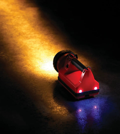 Orange Hand Held Rechargeable Lantern Flashlight With 150 Lumen Output, Up To 80,000 Peak Beam Candlepower shining on ground