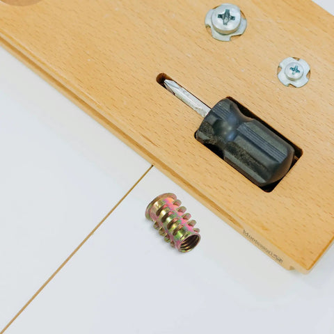 Badass Zinc Alloy Threaded Insert Nuts With Hex Socket Screws And Included Driver For Zero Sweat Furniture Assembly On Cabinets Tables Sofas And Shelves 230 Piece Go To Hardware Kit with driver and nut on wood.