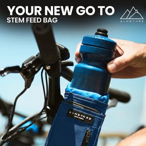 Rider placing bottle into Cosmic Blue 1.6L Adjustable Handlebar Stem Bag With Zipper Pocket Weather Resistant Ripstop Secure Cord
