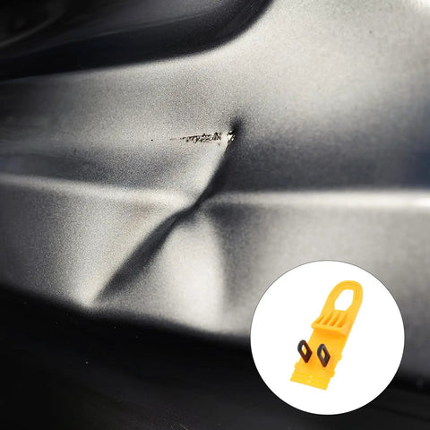 Professional Grade Paintless Dent Removal Kit featuring sturdy pullers on a dented car bumper surface.