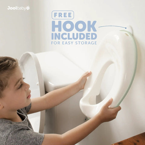 Child holding No Sweat Toddler Potty Training Seat with free storage hook, ready to attach to toilet.