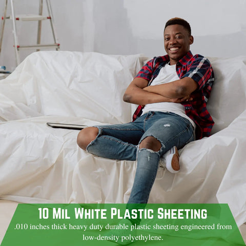 Smiling person sitting on couch covered with 10 mil white plastic sheeting, heavy duty polyethylene film for protection.