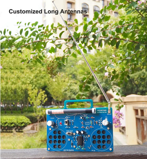 AM FM Radio Kit For DIY Soldering Projects And Electronics Teaching Hands On STEM Gift Dope Stereo Receiver Complete Parts Kit With Full Color Manual Upgraded VT-16 Version Easy Build For Beginners on table with trees in background