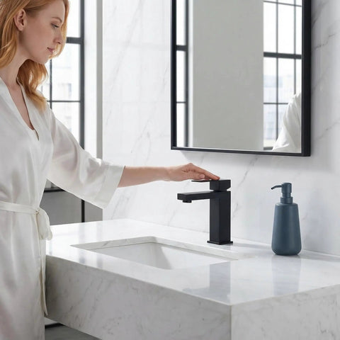 Go To Matte Black Bathroom Faucet With Smooth Single Handle And Included Pop Up Drain, Fresh Square Vanity Sink Tap in use at a marble sink.