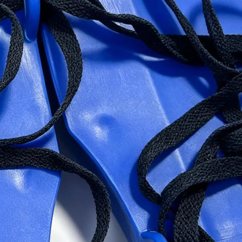 Close-up of Lawn Aerator Shoes With Heavy Duty Adjustable Spiked Soles showing blue plastic material and black laces.