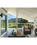 Dope Modern 5 Inch Outdoor Up And Down Wall Lantern In Black Finish on patio with view of mountains and glass railing.