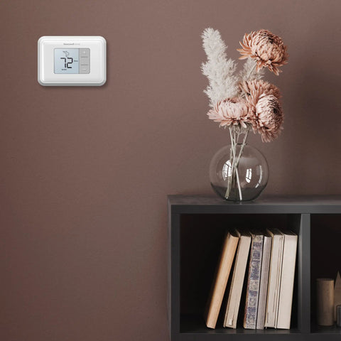Renewed Non Programmable Thermostat With Simple Single Degree Control mounted on wall beside shelf with books and flowers