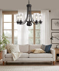 Five Light Matte Black Farmhouse Industrial Chandelier With Clear Glass Shades for living room, above beige sofa.