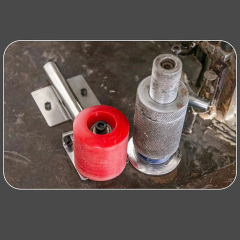 Rock Solid Heavy Duty Polyurethane Conveyor Wheel For 4.33 Inch Manual Edge Banding Machine Stainless Steel Roller on a work surface.