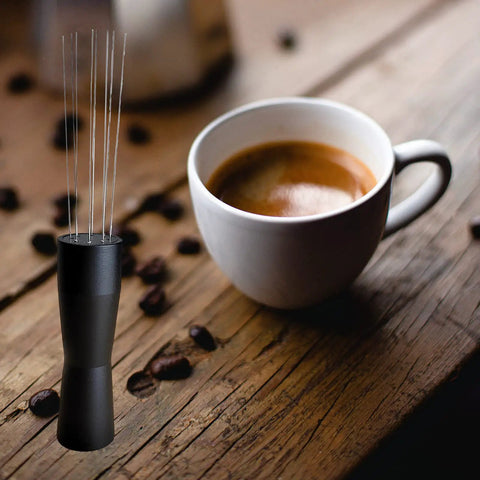 Espresso Distribution Tool Set With Needle Type Distributor beside a cup of espresso on a wooden table, barista setup.