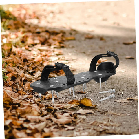 Pair of Pro Grade Lawn Aerator Shoes with 20 heavy-duty metal spikes on a leaf-covered path. Easy to wear lawn care tools.