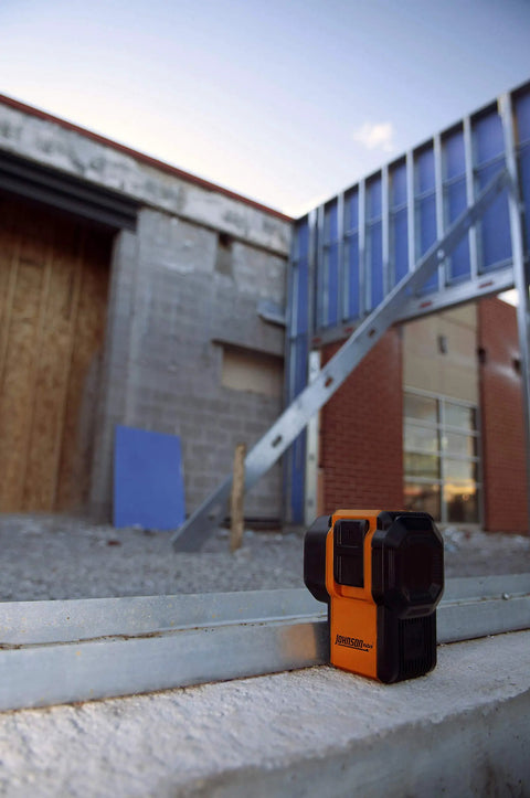 Self Leveling 3 Dot Laser Level With Plumb Up Down Dots And Level Dot 4.5 Inch Red Beam on a construction site wall