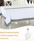 Stainless Steel Tablecloth Weights With Clips, Star Shaped Pendant 4 Pack on white tablecloth, outdoor dining decor, silver.