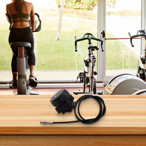 Fine Tuned Resistance Rotary Adjuster For Exercise Bike With Eight To Ten Gear System placed on a wooden table.