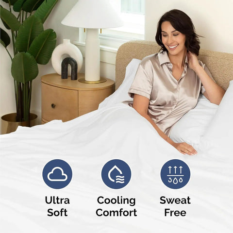 King Size Four Piece Sheet Set With Chill Cooling Fabric And Deep Pockets Up To Sixteen Inches on bed with smiling woman.