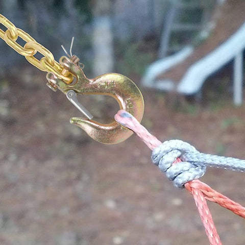 4 Pack 1/4 Inch G70 Forged Steel Clevis Slip Hook With Spring Safety Latch attached to rope for rigging and towing use.
