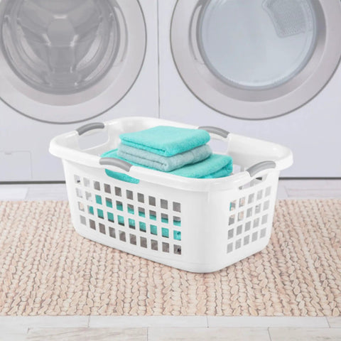 Ultra 2 Bushel Plastic Laundry Hamper Baskets, 6 Pack in White placed in front of a washing machine with folded towels inside