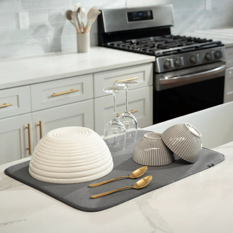Top Shelf Microfiber Dish Drying Mat Extra Large 18 X 24 Inch Countertop Pad with wet plates and glasses on a grey mat.