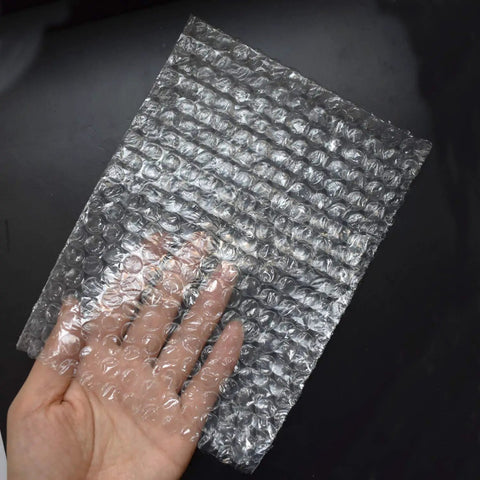Hand holding 6x8 inch clear 100 Pack 6x8 Inch Bubble Out Bags Double Sided Cushioning Pouches For Moving Shipping And Storage