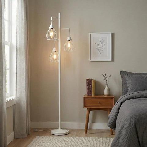 White Teardrop Modern LED Floor Lamp With Three Cage Shades in bedroom setting with warm Edison bulbs