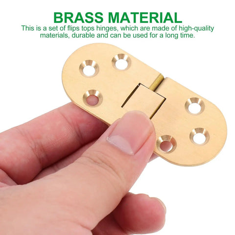 Close-up of Brass Table Hinges 2-Piece Set For Butler Tray And Cabinet Furniture, held by hand, showing smooth gold finish and screw holes.