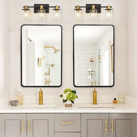 Three Light Black And Gold Bathroom Vanity Light Fixtures Over Mirror With Clear Glass Shade above double mirrors in bathroom